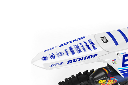 White yamaha dirt bike with white plastics and blue, cyan, and white design side view